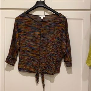 Light sweater top with tie.